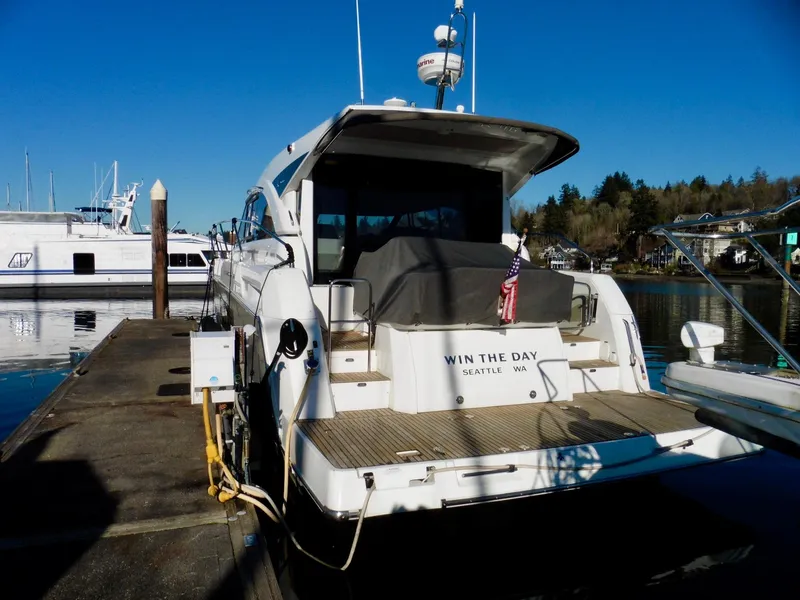 Slide: The Image of 2017 Jeanneau Leader 46 yacht docked, rear view, with "Win the Day" text, Seattle location. - 7