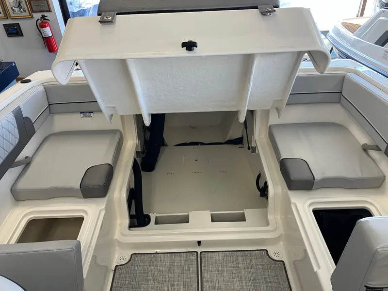 Slide: The Image of 2024 Bayliner VR4 Bowrider OB interior with open storage compartments and cushioned seating. - 3