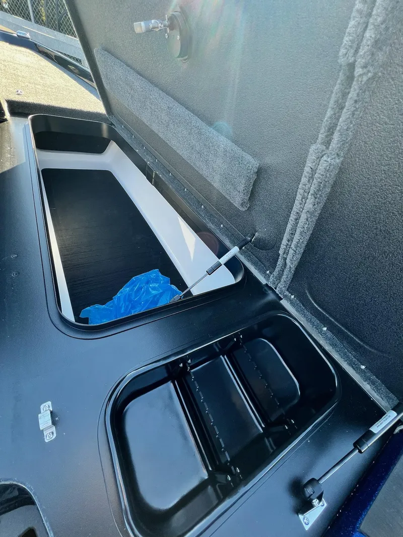 Slide: The Image of Open storage compartment in 2025 Skeeter ZXR 20 SE boat, showcasing interior details. - 15
