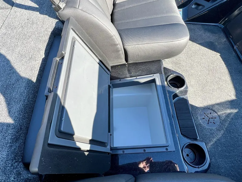 Slide: The Image of 2025 Skeeter ZXR 20 SE boat interior with open storage compartment and cup holders. - 17