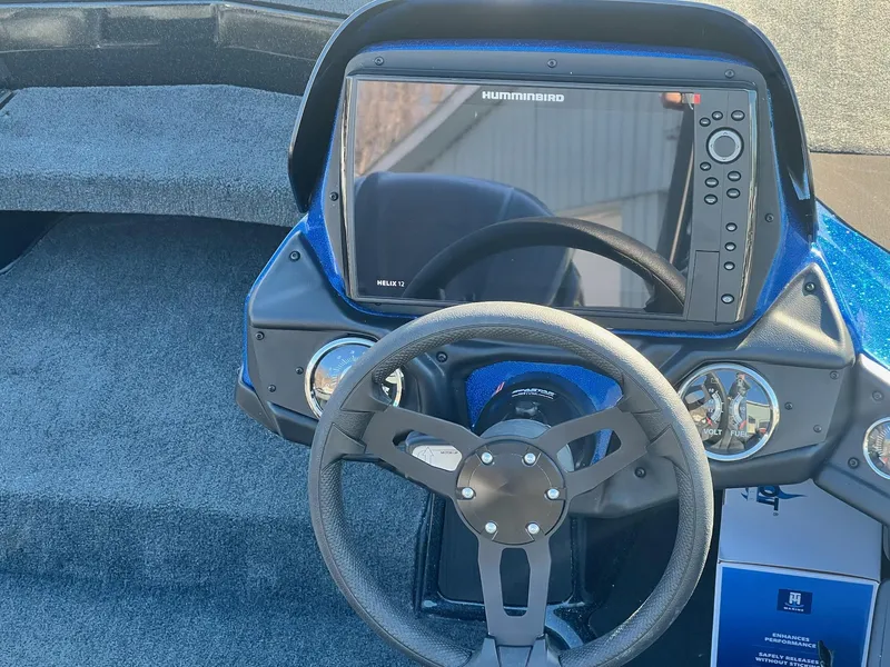 Slide: The Image of 2025 Skeeter ZXR 20 SE boat dashboard with Humminbird Helix 12 display and steering wheel. - 18