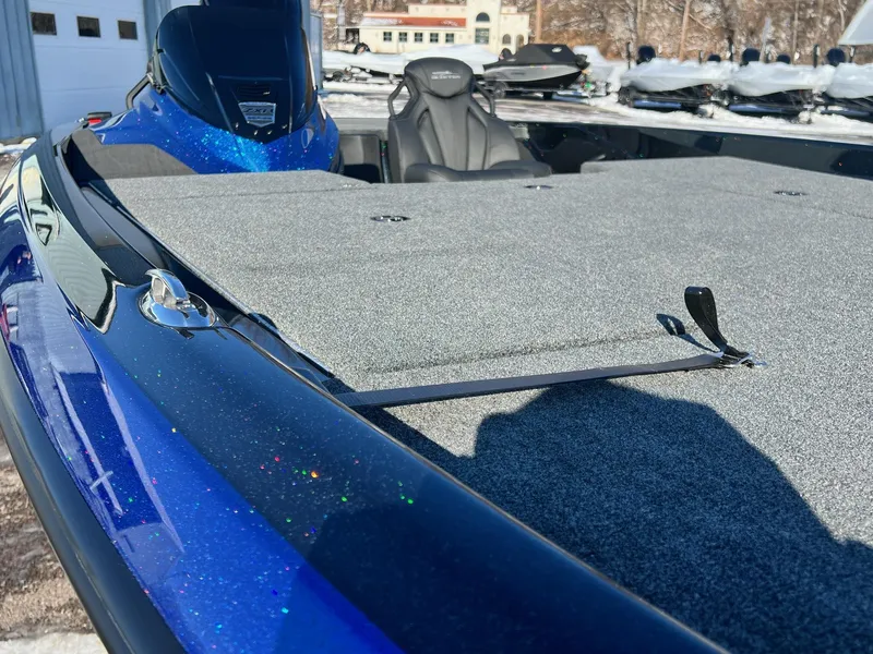Slide: The Image of 2025 Skeeter ZXR 20 SE boat with blue metallic finish and spacious deck. - 24