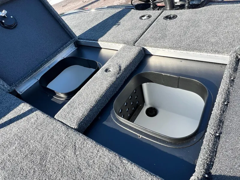 Slide: The Image of 2025 Skeeter ZXR 20 SE boat storage compartments with open lids, showcasing interior design. - 25