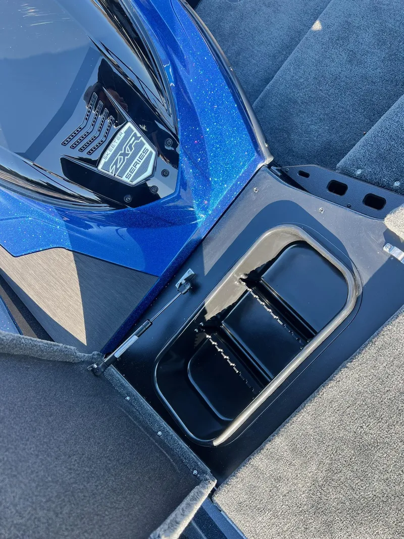Slide: The Image of 2025 Skeeter ZXR 20 SE boat interior with storage compartment and sleek blue design. - 3