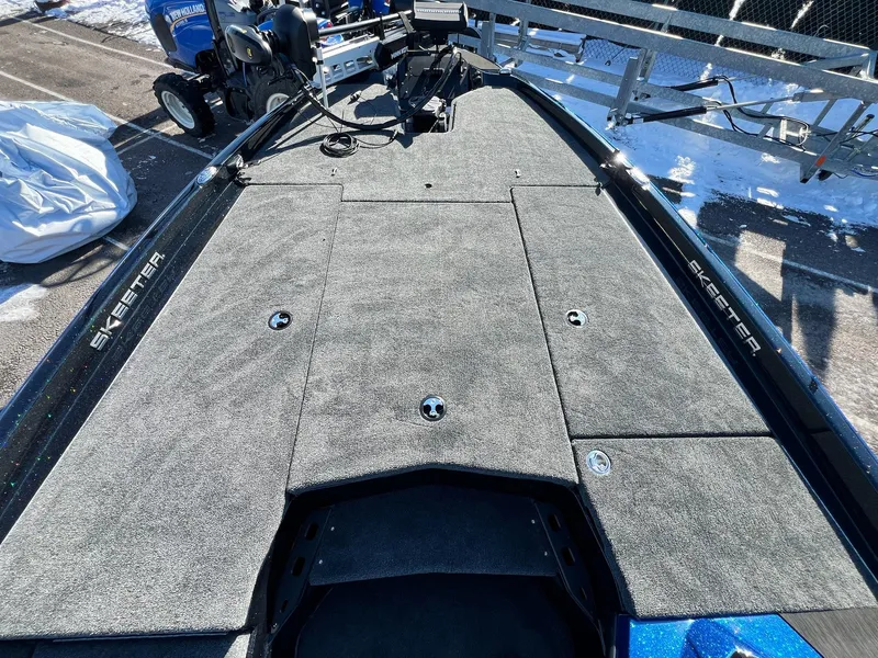 Slide: The Image of 2025 Skeeter ZXR 20 SE boat deck with carpeted surface and storage compartments. - 34