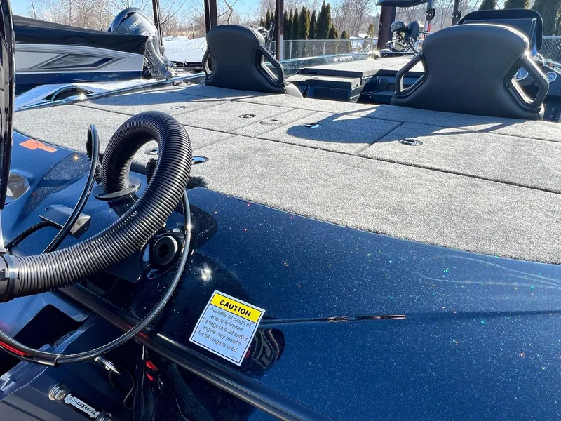 Slide: The Image of 2025 Skeeter ZXR 20 SE boat deck with seating and caution label. - 7