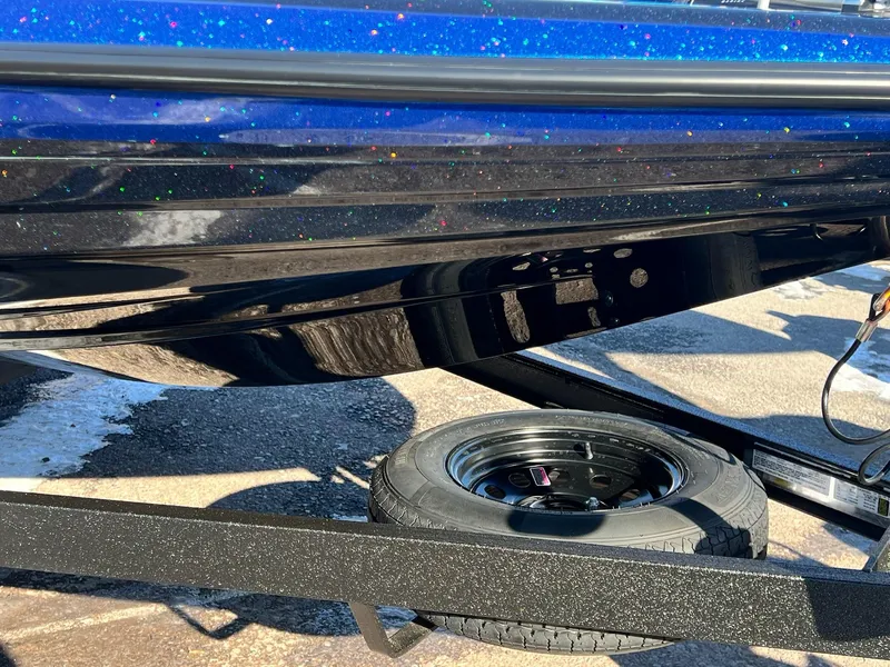 Slide: The Image of 2025 Skeeter ZXR 20 SE boat with glittery blue finish on a trailer. - 9