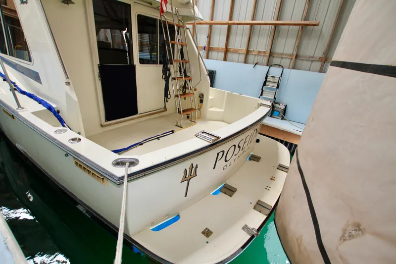 Slide: The Image of 1989 Tollycraft 34 Sport Sedan docked in a covered marina. - 10