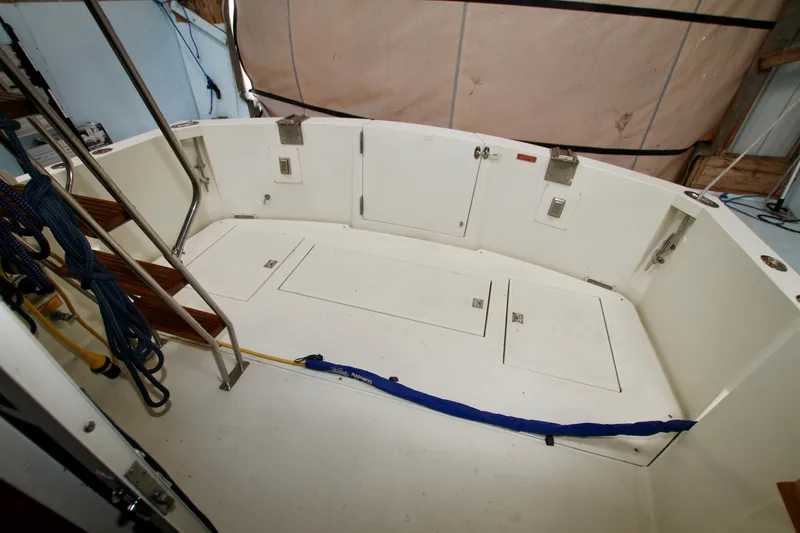 Slide: The Image of 1989 Tollycraft 34 Sport Sedan boat deck with storage compartments and ladder. - 12