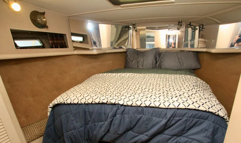 Slide: The Image of 1989 Tollycraft 34 Sport Sedan cabin with cozy bed and nautical decor. - 14