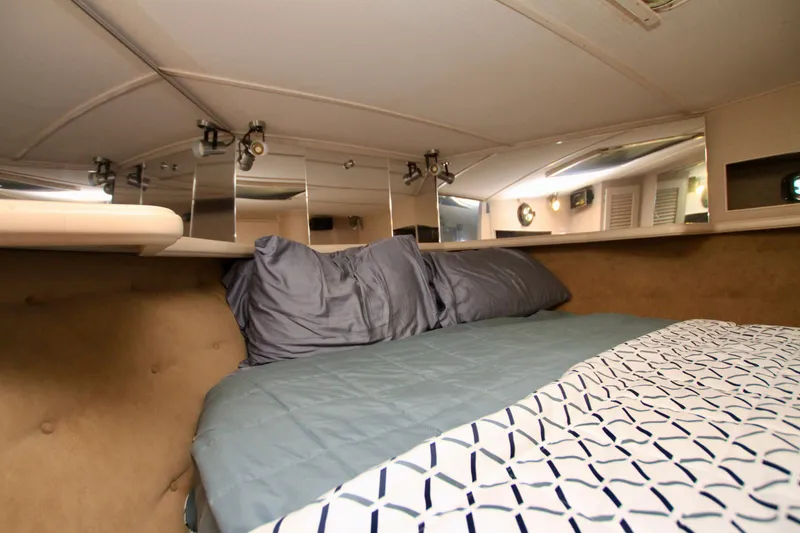 Slide: The Image of 1989 Tollycraft 34 Sport Sedan cabin with cozy bed and modern lighting. - 16