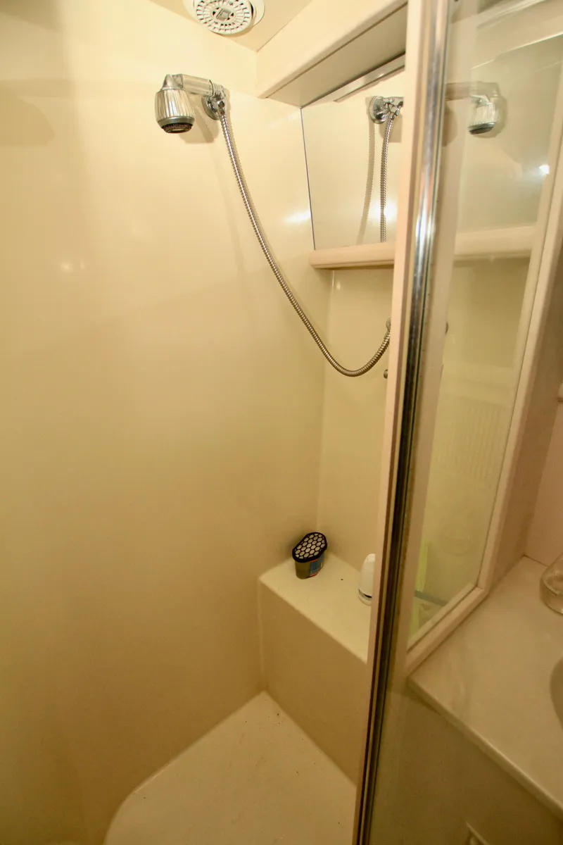 Slide: The Image of Shower area in 1989 Tollycraft 34 Sport Sedan yacht, featuring a handheld showerhead. - 19