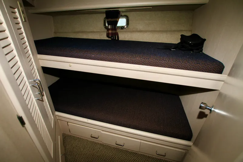 Slide: The Image of 1989 Tollycraft 34 Sport Sedan cabin with bunk beds and storage drawers. - 22