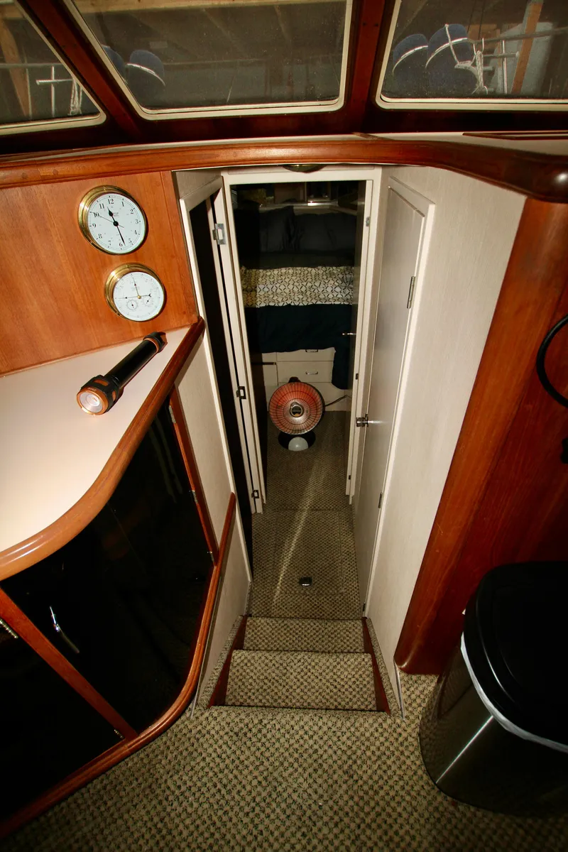 Slide: The Image of 1989 Tollycraft 34 Sport Sedan interior with wood paneling and nautical instruments. - 25