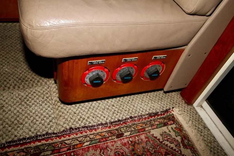 Slide: The Image of 1989 Tollycraft 34 Sport Sedan interior with control dials and carpeted flooring. - 26