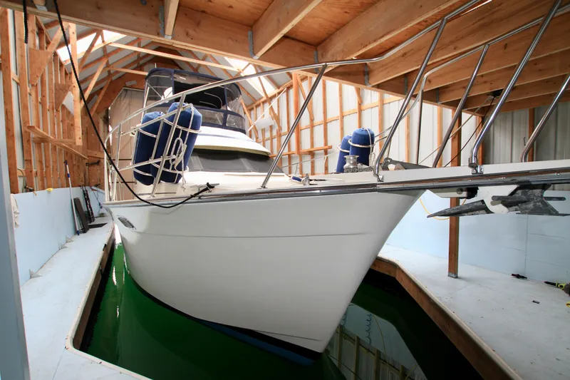 Slide: The Image of 1989 Tollycraft 34 Sport Sedan docked in a wooden boathouse. - 3