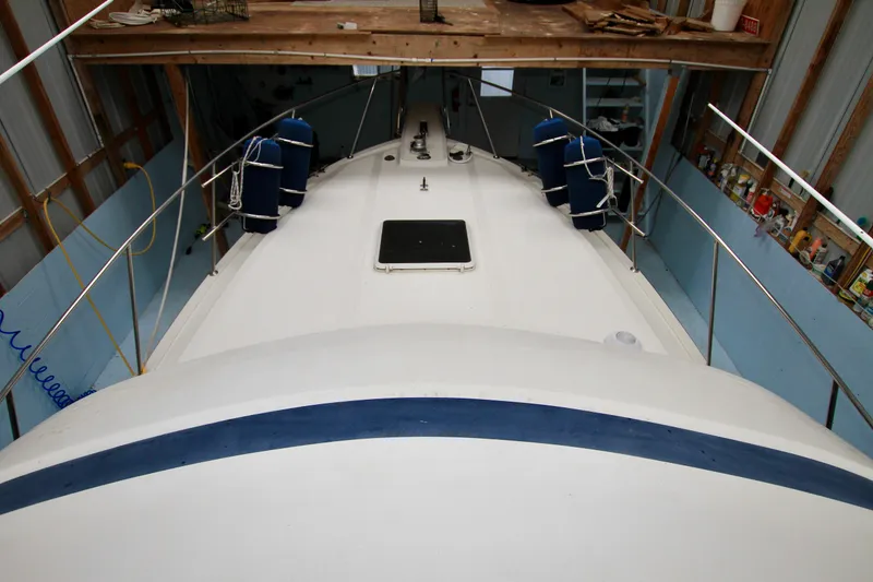 Slide: The Image of 1989 Tollycraft 34 Sport Sedan boat in storage, view of deck and railings. - 34