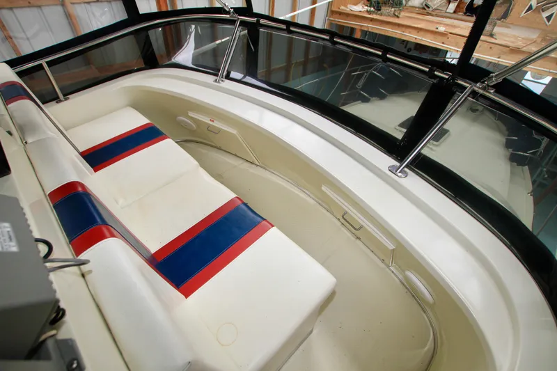 Slide: The Image of 1989 Tollycraft 34 Sport Sedan interior with white seating and red-blue accents. - 38