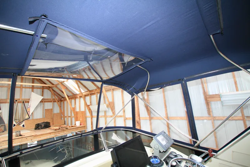 Slide: The Image of 1989 Tollycraft 34 Sport Sedan interior with blue canopy and navigation equipment. - 39