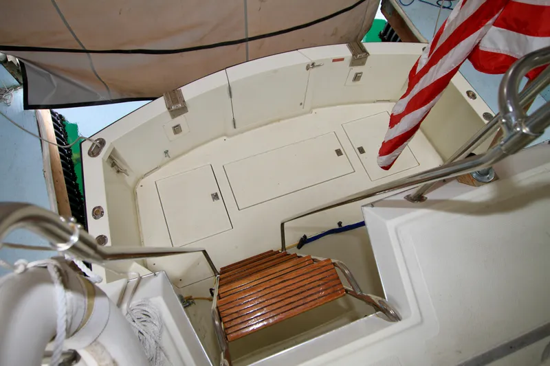 Slide: The Image of 1989 Tollycraft 34 Sport Sedan boat deck with wooden steps and American flag. - 42