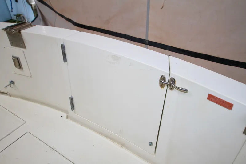 Slide: The Image of 1989 Tollycraft 34 Sport Sedan boat deck with storage compartment and latch. - 44