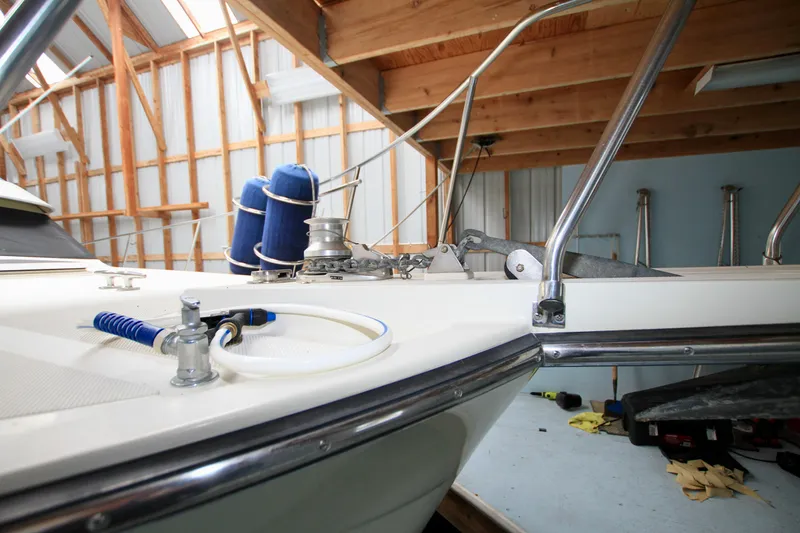 Slide: The Image of 1989 Tollycraft 34 Sport Sedan boat in a wooden boathouse, showcasing deck details. - 5