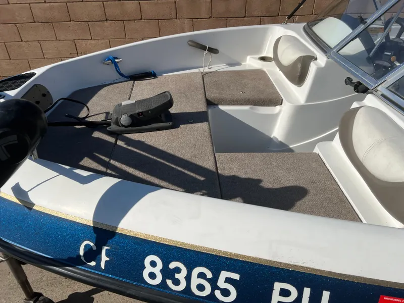 Slide: The Image of 2002 Nitro 188 Sport boat interior with carpeted deck and seating, registration number visible. - 14