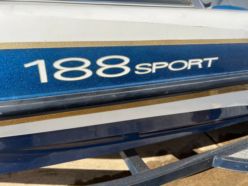 Slide: The Image of 2002 Nitro 188 Sport boat, blue and white exterior with gold accents. - 17