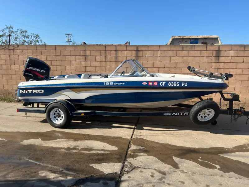 Slide: The Image of 2002 Nitro 188 Sport boat on trailer, parked outdoors. - 2