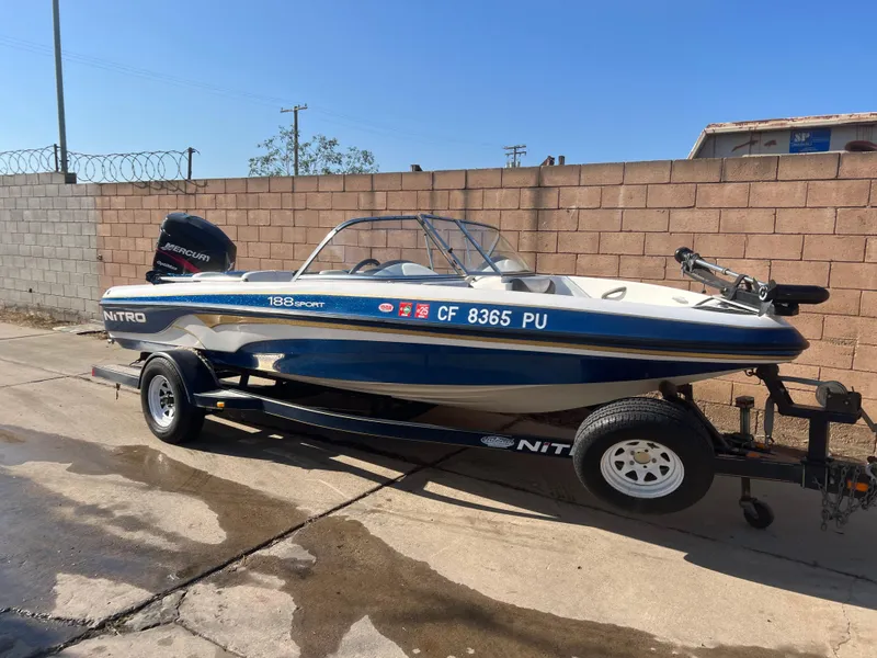 Slide: The Image of 2002 Nitro 188 Sport boat on trailer, parked outdoors. - 3