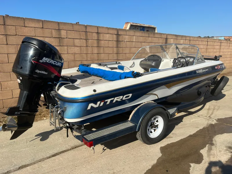 Slide: The Image of 2002 Nitro 188 Sport boat with Mercury outboard motor, parked on a trailer. - 4
