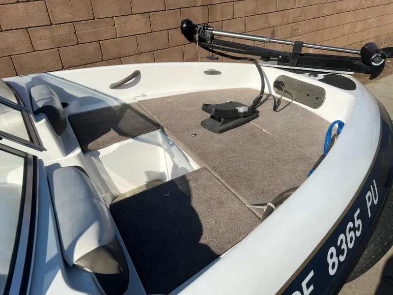 Slide: The Image of 2002 Nitro 188 Sport boat deck with mounted equipment, against a brick wall. - 6