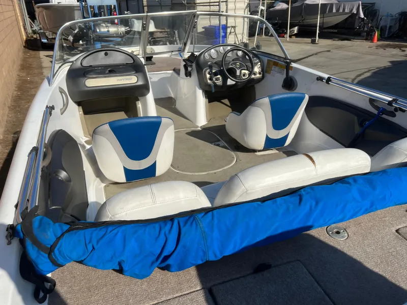 Slide: The Image of 2002 Nitro 188 Sport boat interior with blue and white seating, steering wheel, and dashboard. - 8