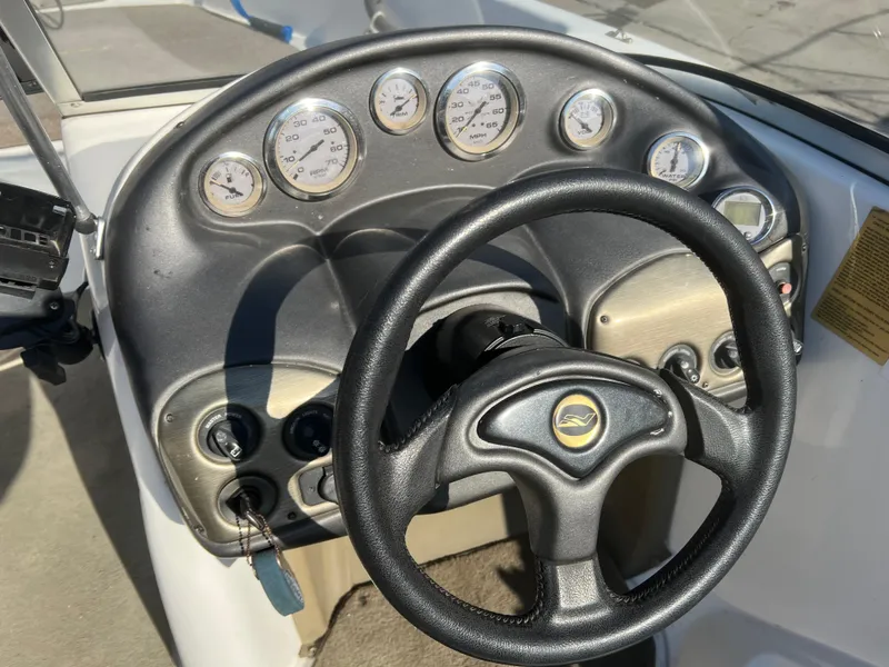 Slide: The Image of Dashboard of a 2002 Nitro 188 Sport boat with gauges and steering wheel. - 9
