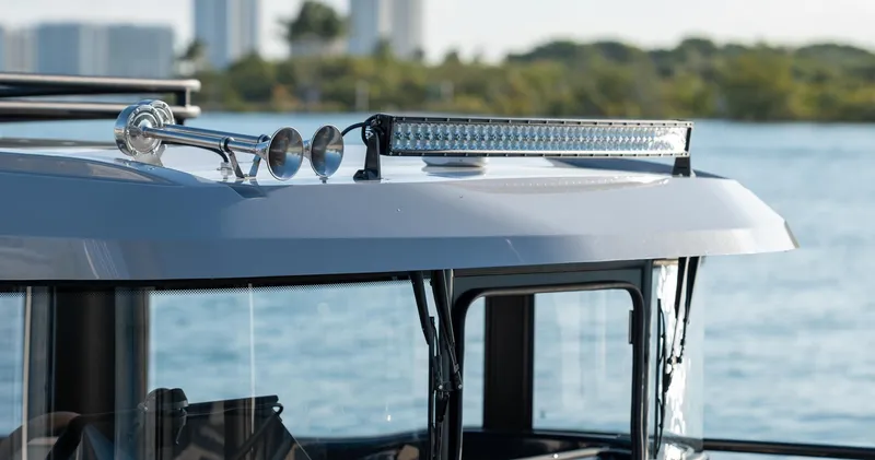 Slide: The Image of 2023 Arksen 30 boat roof with horn and light bar, near water. - 28
