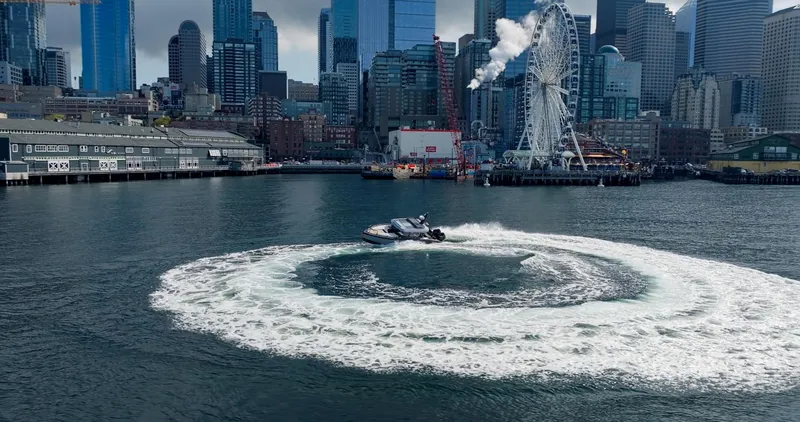 Slide: The Image of Arksen 30 boat performing a circular maneuver in a city harbor, 2023. - 3