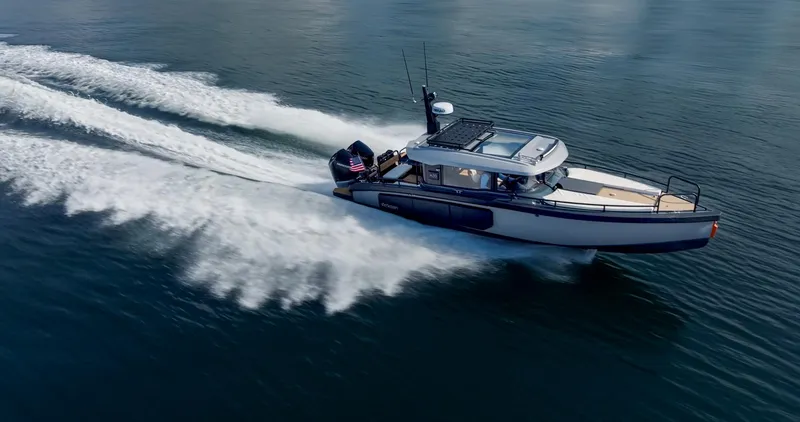Slide: The Image of 2023 Arksen 30 boat speeding on water, creating a dynamic wake. - 6