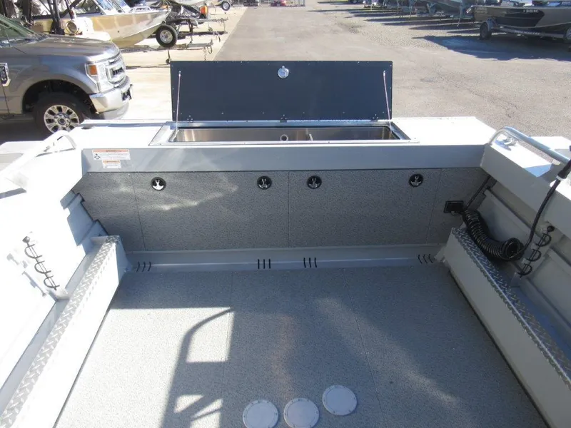 Slide: The Image of 2025 Hewescraft 200 PRO V ET boat interior with storage compartments and seating. - 11