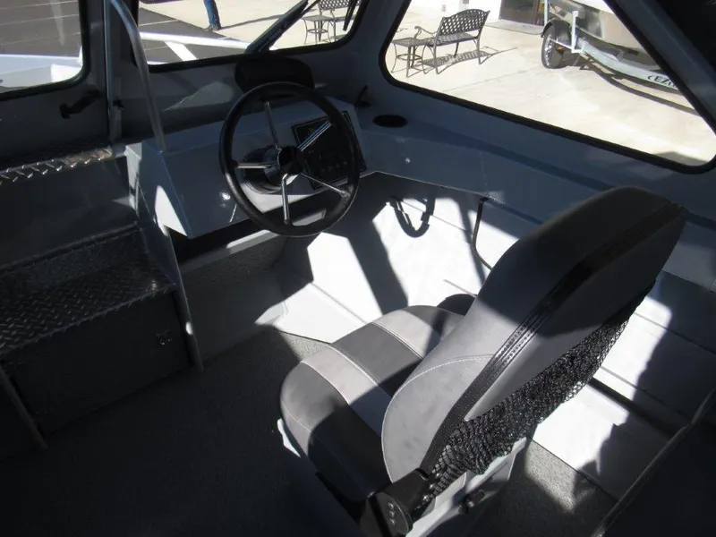 Slide: The Image of Interior of 2025 Hewescraft 200 PRO V ET boat, featuring steering wheel and seating. - 12
