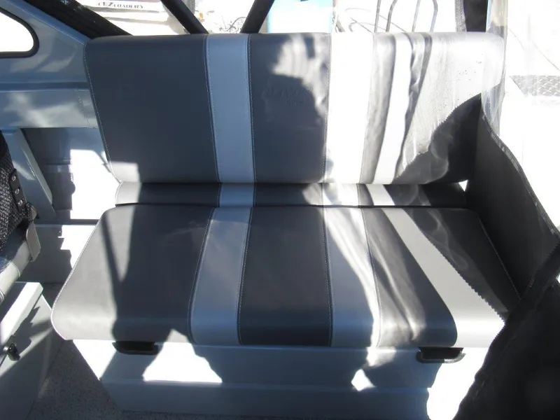 Slide: The Image of Interior seating of 2025 Hewescraft 200 PRO V ET boat, featuring gray and white upholstery. - 15