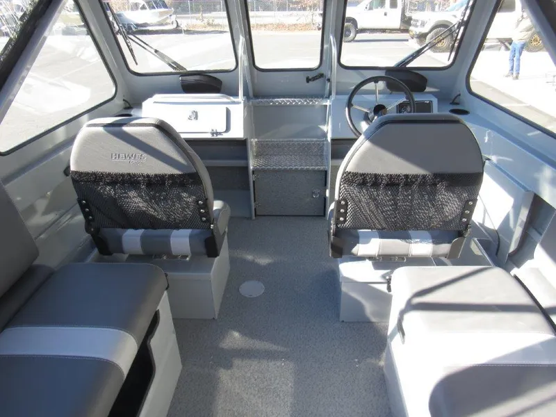 Slide: The Image of Interior of 2025 Hewescraft 200 PRO V ET boat, featuring seating and steering area. - 17