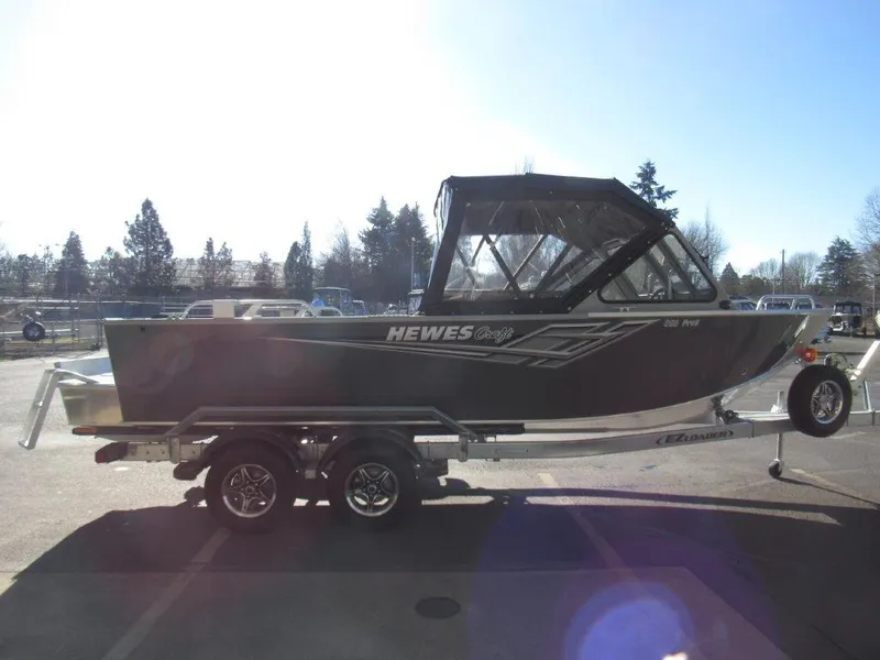 Slide: The Image of 2025 Hewescraft 200 PRO V ET boat on trailer, parked outdoors. - 6