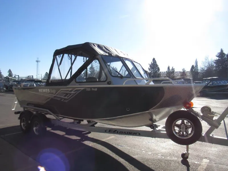 Slide: The Image of 2025 Hewescraft 200 PRO V ET boat on trailer in sunny outdoor setting. - 7