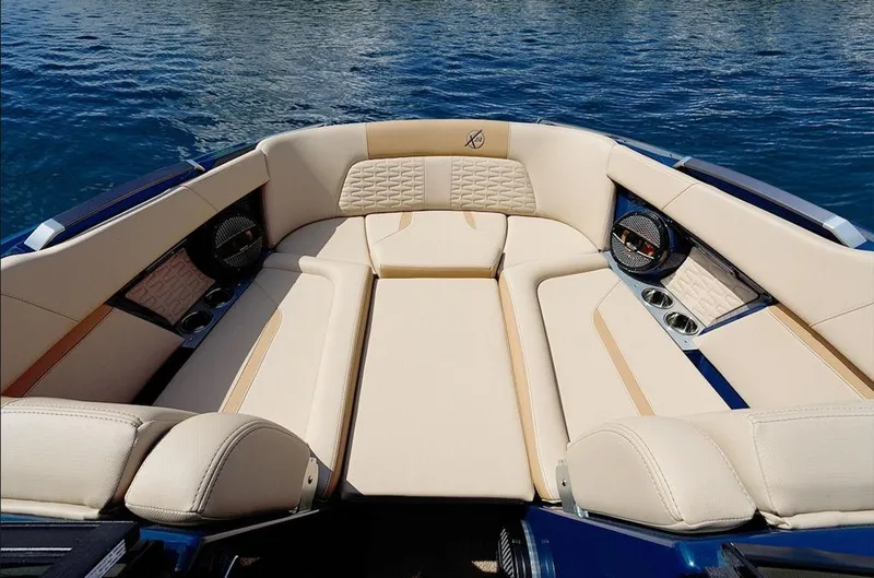 Slide: The Image of Luxurious interior of 2025 MasterCraft X24 boat with beige seating and speakers. - 1
