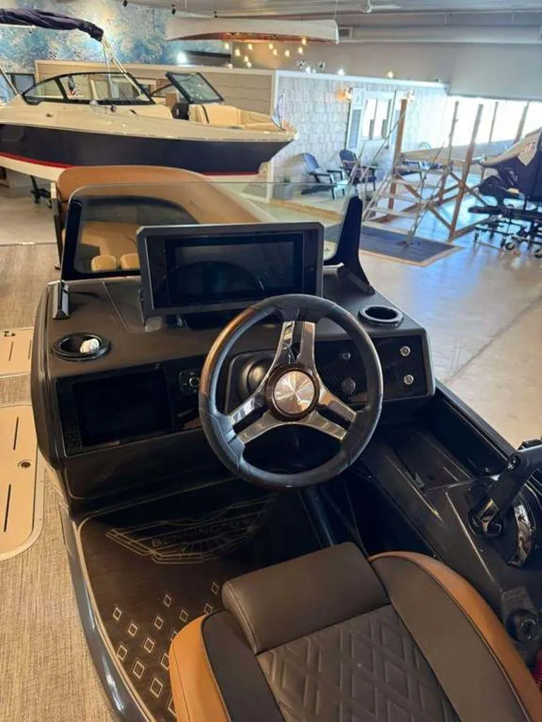 Slide: The Image of Interior view of 2025 Bennington M Swingback 24 MSB boat with steering wheel and dashboard. - 4