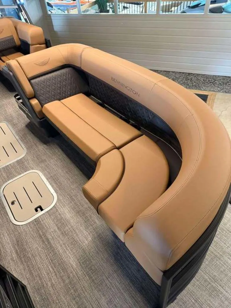 Slide: The Image of Luxurious seating on 2025 Bennington M Swingback 24 MSB pontoon boat, featuring tan upholstery. - 5