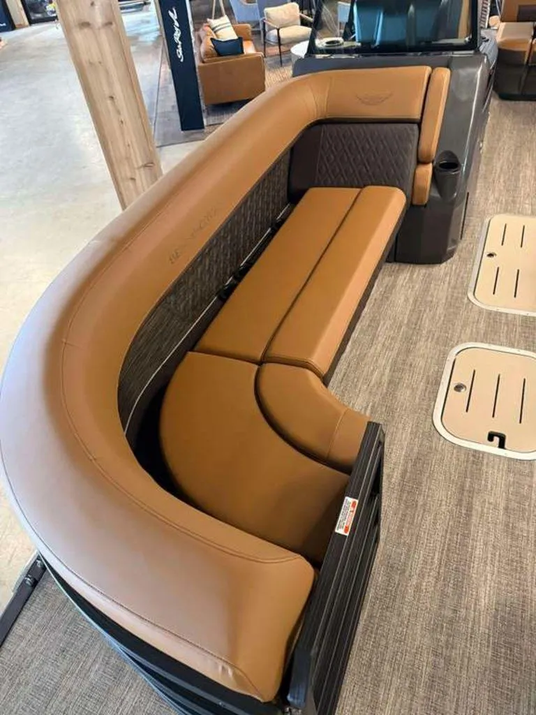 Slide: The Image of 2025 Bennington M Swingback 24 MSB boat interior with brown leather seating. - 6