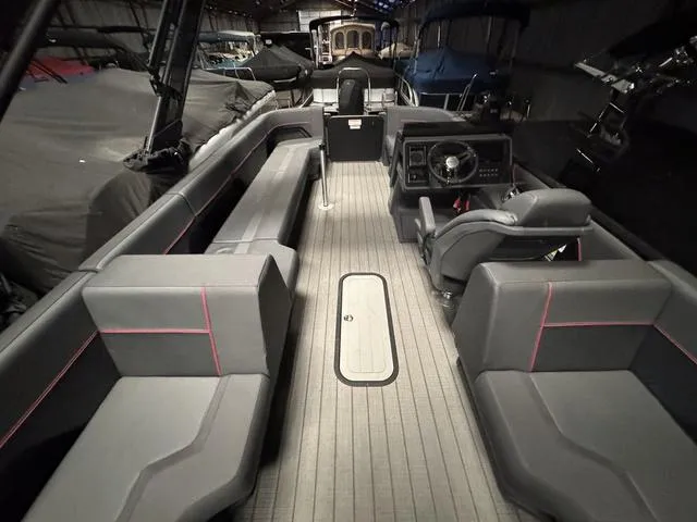 Slide: The Image of 2023 Manitou Explore 22 Max Bench interior with gray seating and modern dashboard. - 13