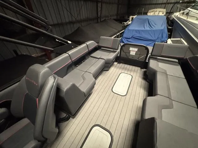 Slide: The Image of 2023 Manitou Explore 22 Max Bench interior with spacious seating and modern design. - 16