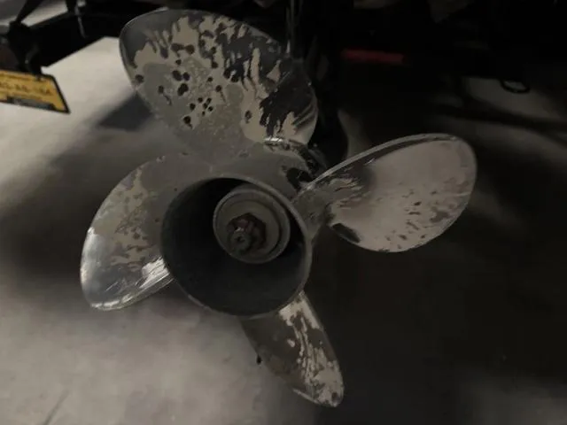 Slide: The Image of Propeller of 2023 Manitou Explore 22 Max Bench boat, close-up view. - 22